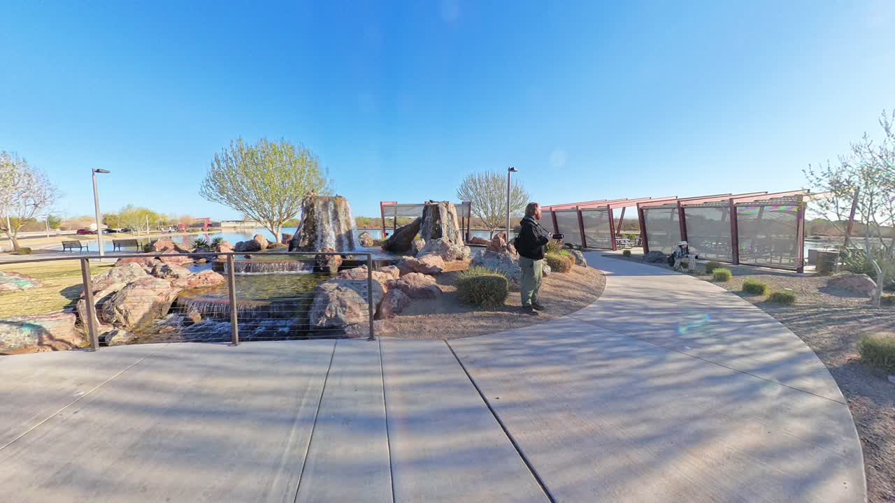 Red haired male photographing Mandarin Duck at Mansel Crater Park in Queen Creek Arizona.