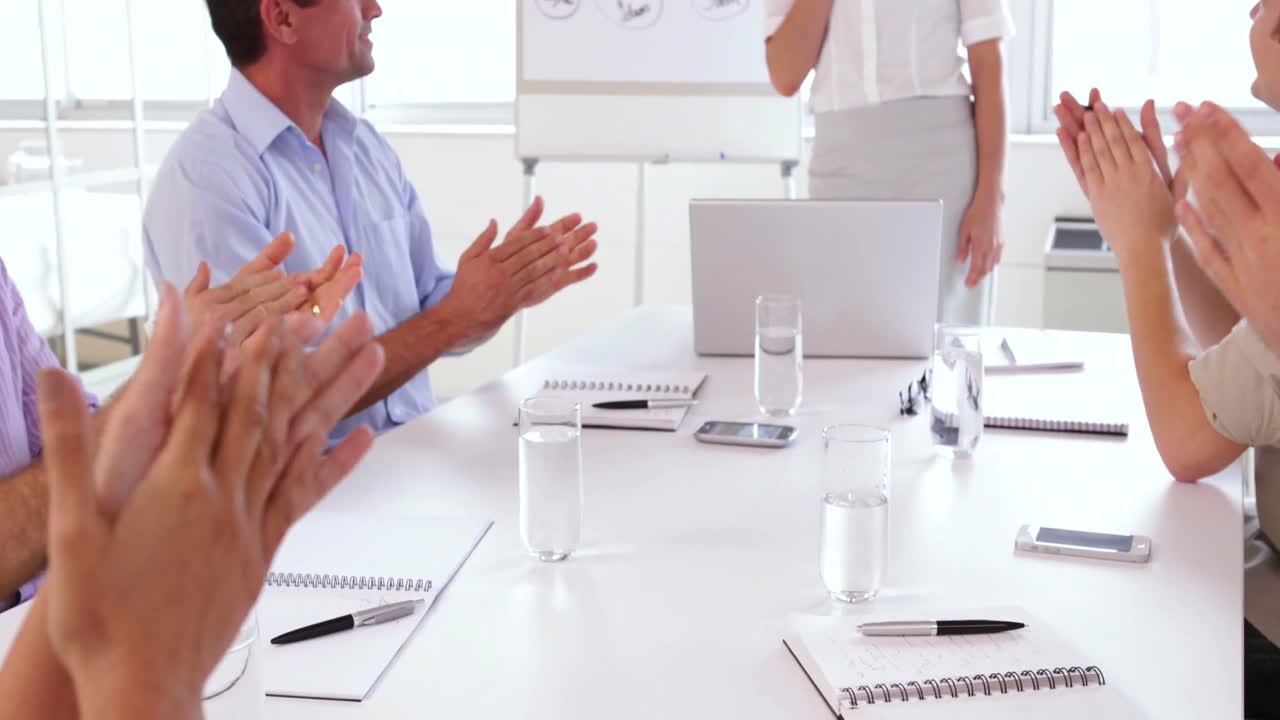 Business team applauding after a presentation 