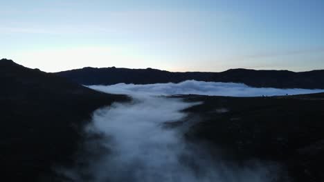 aerial view of a beautiful valley covered with fog and clouds floating