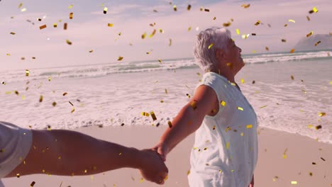 animation of confetti over happy diverse senior couple on beach