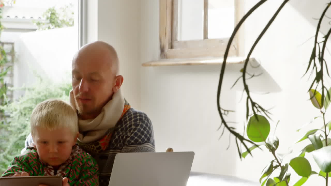 Caucasian man and his son during coronavirus covid19 pandemic with words Stay Home