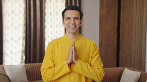 religious indian man greeting and doing namaste