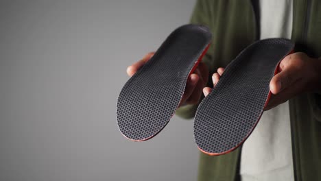 person holding comfortable shoe insoles