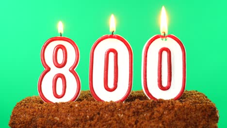 cake with the number 800 lighted candle. chroma key. green screen. isolated