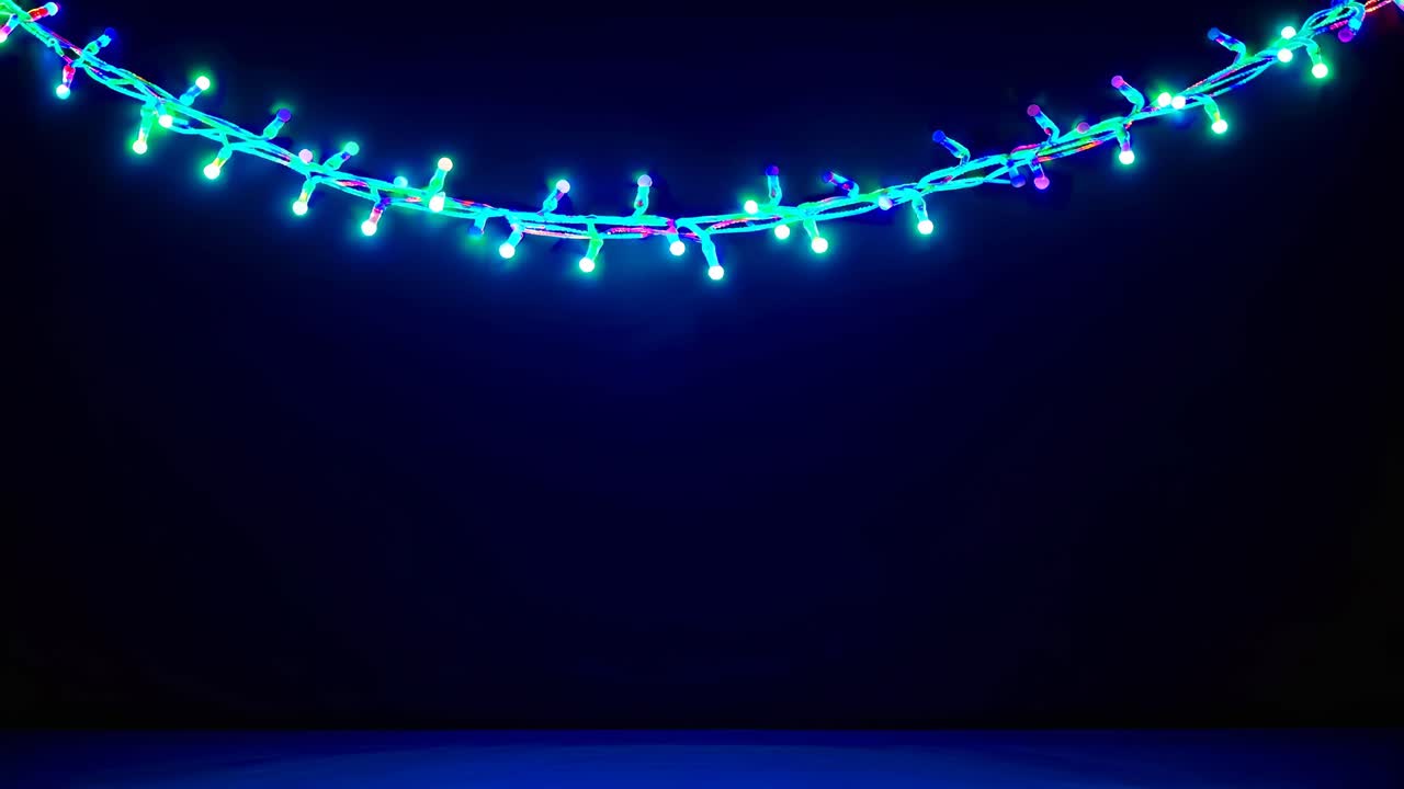 Colorful string lights against a dark background, captured from a low angle