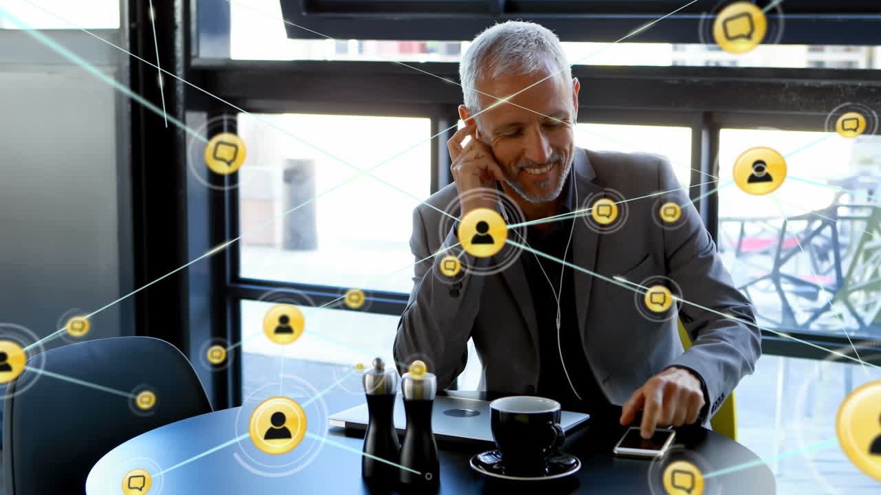 Animation of network of connections with people icons over caucasian businessman using smartphone