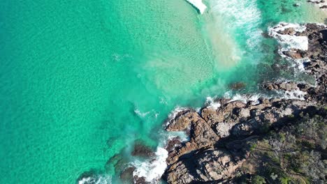 aerial view of devil's kitchen rock and allie cove beach on a sunny day in noosa heads, qld, australia