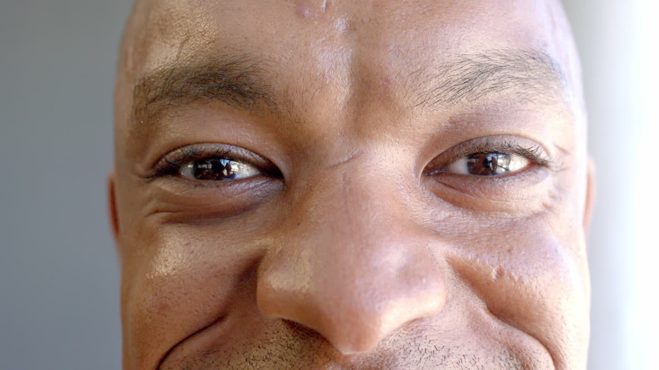 Smiling African American man with close-up of eyes and face, showing happiness and confidence