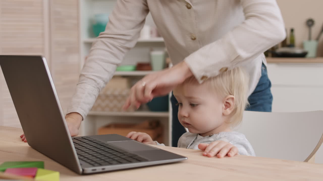Toddler Using Laptop Computer of Parent