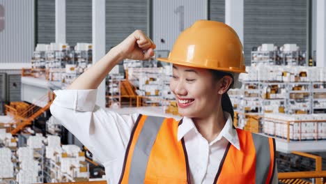 happy female engineer in a warehouse