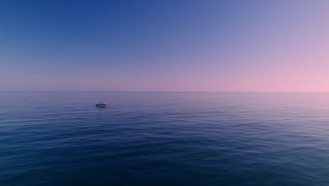 aerial view of mediterranean sea during dusk hours with boat in the horizon