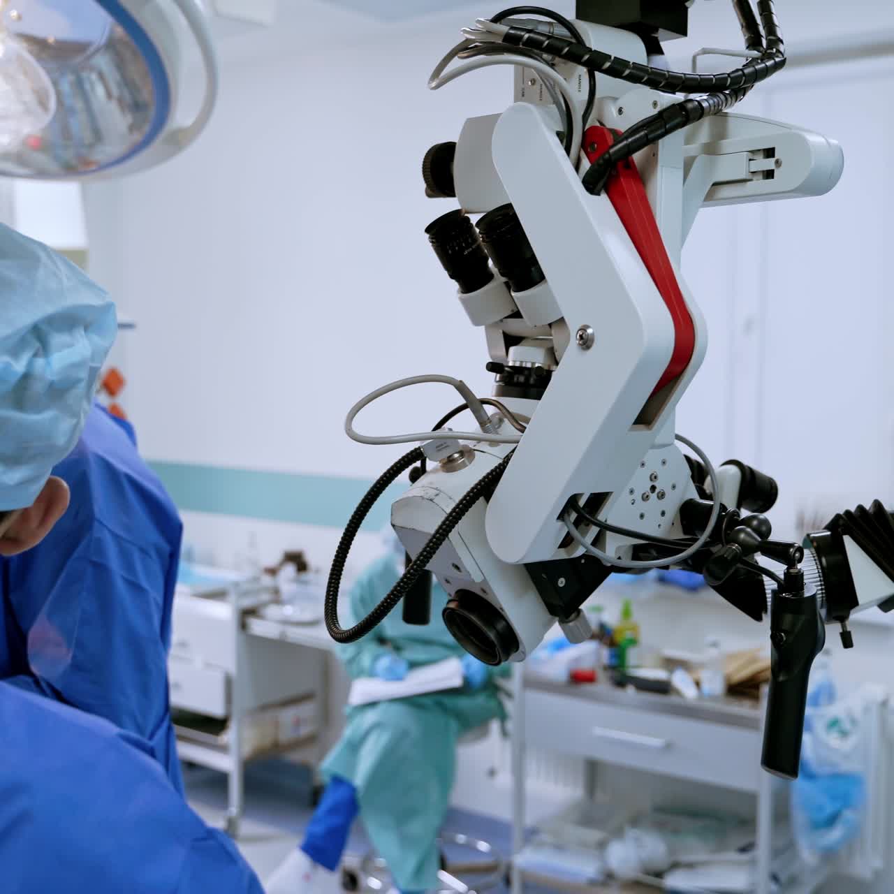 Teamwork of surgeons during surgery. Modern medical equipment in the operating room. Group of doctors in medical uniform.