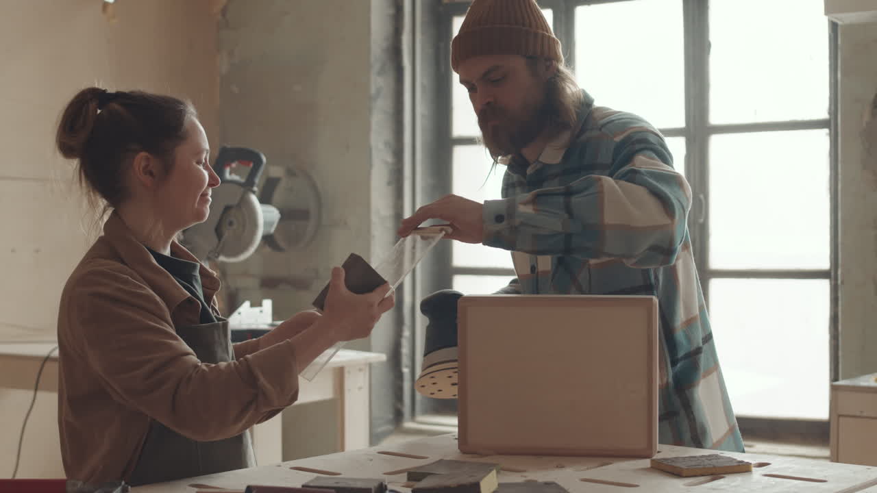 Man and Woman Polishing Parts of Wooden Box