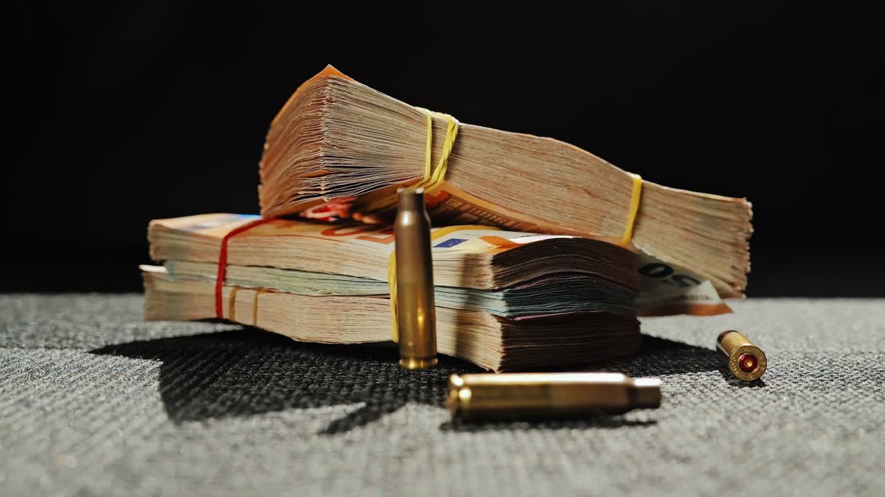 Falling shell casings hit stacks of money symbolizing violence and illegal trade