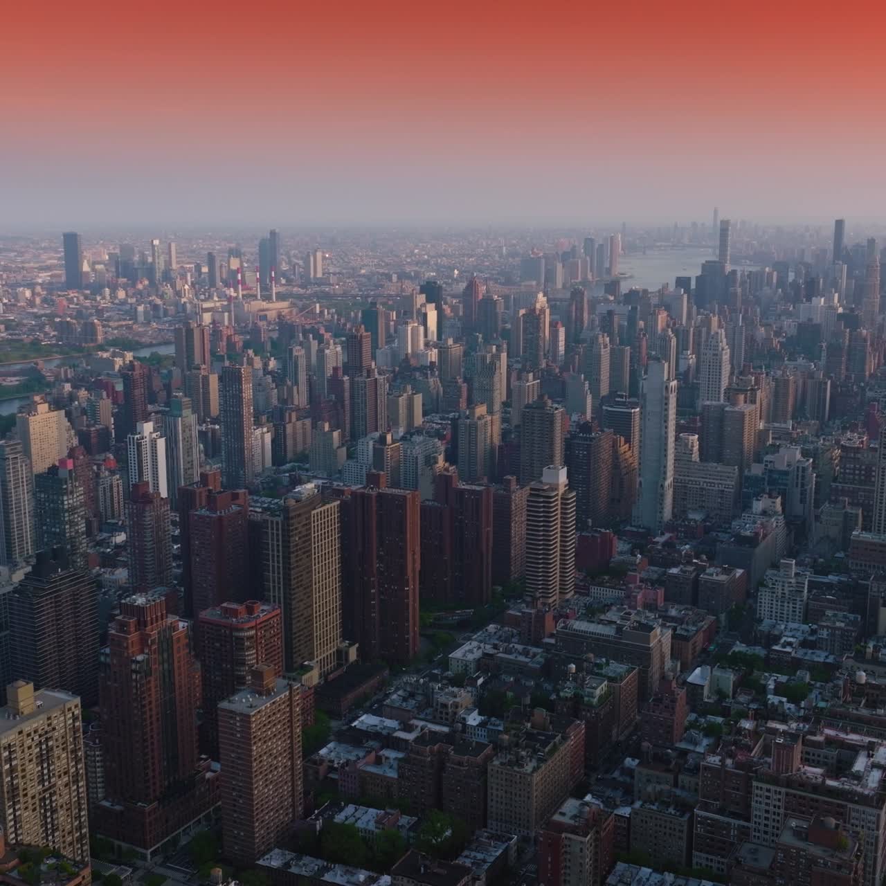 Impressive New York cityscape at sunrise. Beautiful quarters and streets of a metropolis. Pink sky backdrop