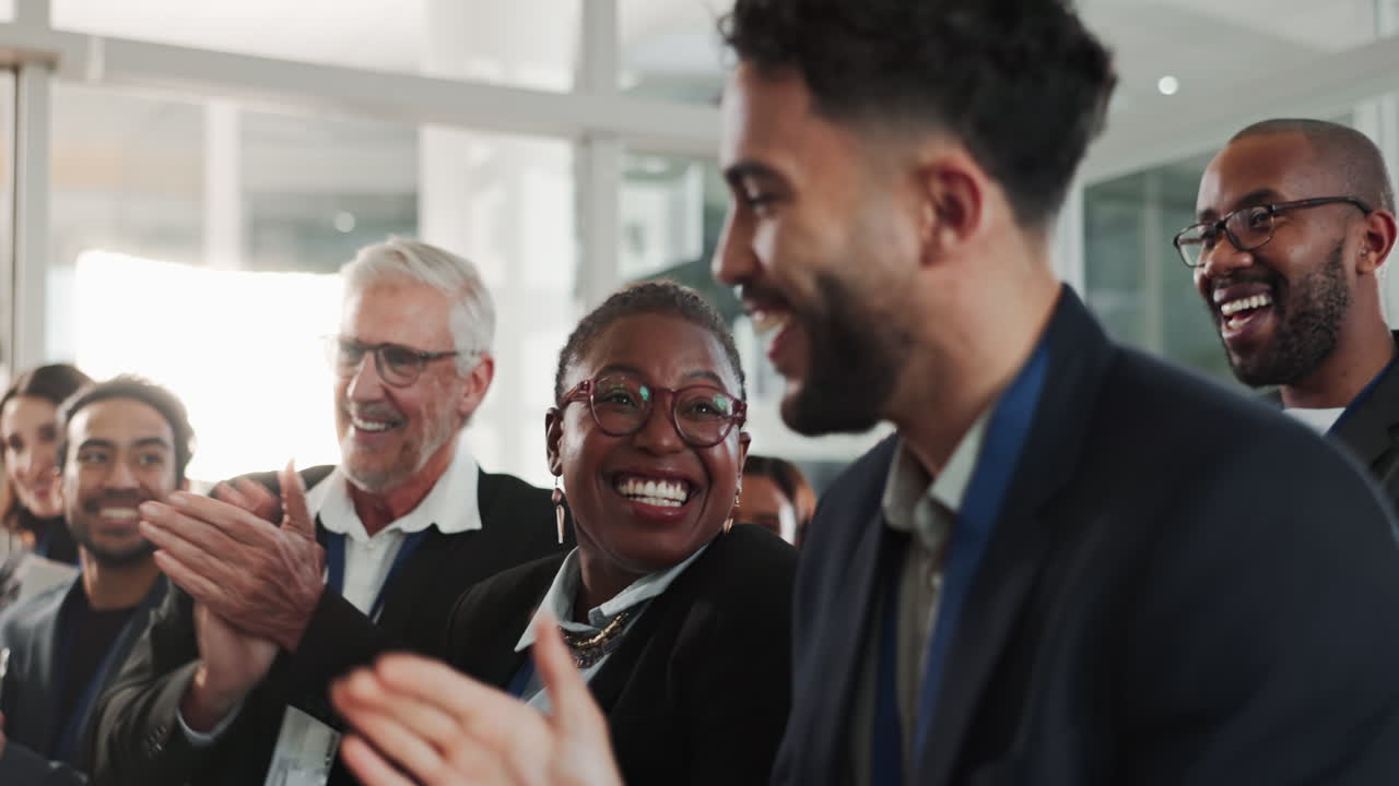 Diverse group of professionals clapping and celebrating together at a business meeting