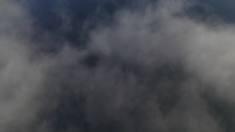 freshwater lake barrine revealed behind clouds in atherton tableland, fnq, australia