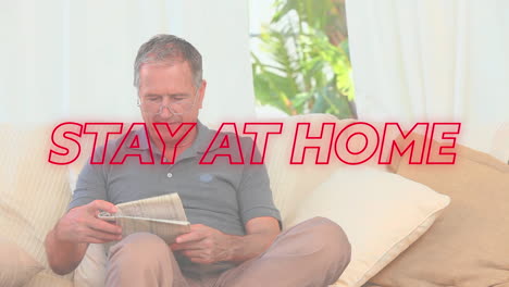 animation of neon colourful text stay at home over senior caucasian man reading book