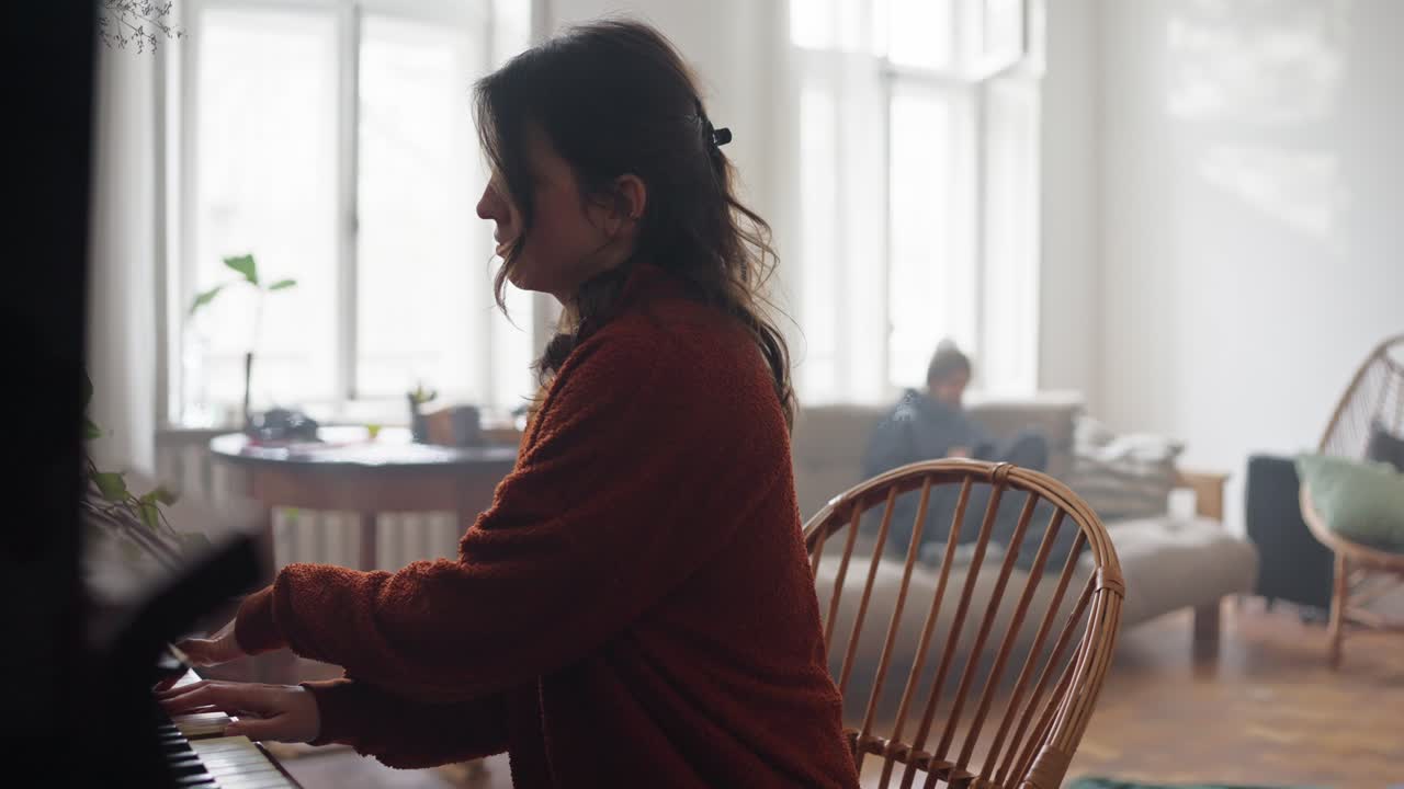 Woman playing piano in a cozy living room