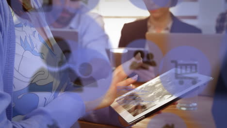 animación de íconos digitales sobre la sección media de la sección central de una mujer usando una tableta digital en la oficina