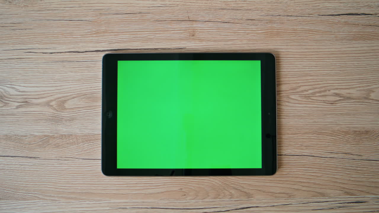 Top green screen tablet at remote home workplace closeup. Corporate workspace