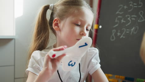 Girl-fans-with-plastic-digit-cards-doing-maths-with-sibling