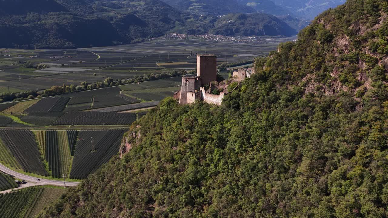 Neuhaus Castle Ruins Neuhaus Castel Maultasch, hill top castle. in the area of Terlano, Terlan. Overlooking valley of apple plantations. Aerial drone video