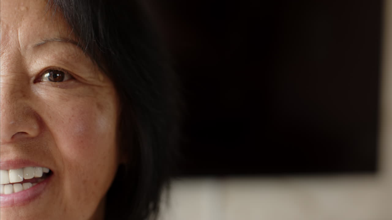Senior woman sitting peacefully at home, smiling and relaxing in cozy atmosphere