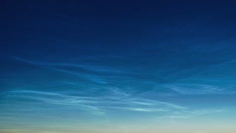 Beautiful-time-lapse-of-silvery-clouds-glowing-and-shining-in-a-summer-evening,-calm-and-tranquil-scenic-view-after-the-sunset,-cityscape,-wide-angle-shot