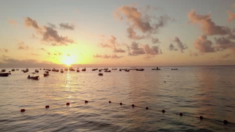 AERIAL---Boats-anchored-at-sunrise-off-the-coast-of-Cancun,-Mexico,-forward-shot