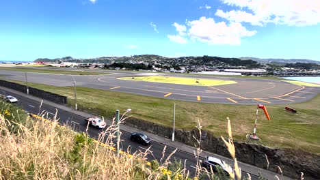 traffic on the airport road with view of the airport taxiway