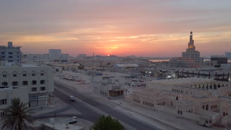 sunset sky line of doha qatar, with views of "abdulla bin zaid al mahmoud islamic cultural center" also knowen as "bin zaid", filmed in 4k from a high building