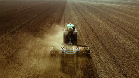 tractor handles expansive dry land, aerial shot
