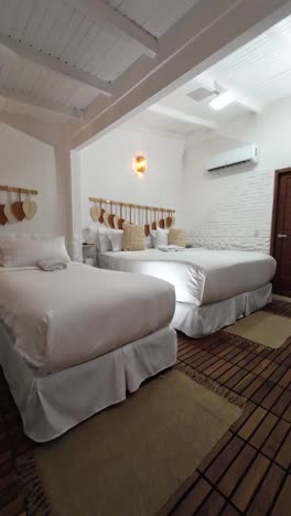 headboard beds made of wooden rod with decorative macrame pieces. white macrame hammock is suspended, adding a bohemian touch
