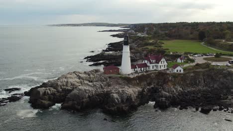 aerial shot of historical lighthouse on a rocky coastline