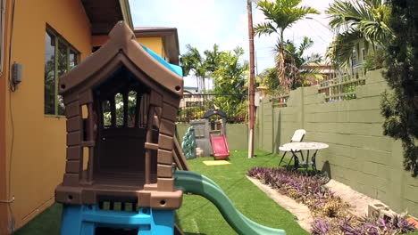 Suburban-backyard-with-kids-playhouse-on-a-windy-day