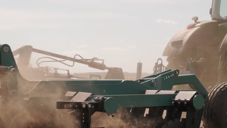 a tractor plowing a dry agricultural field, preparing land for planting. agricultural industry. processing the field on the farm.