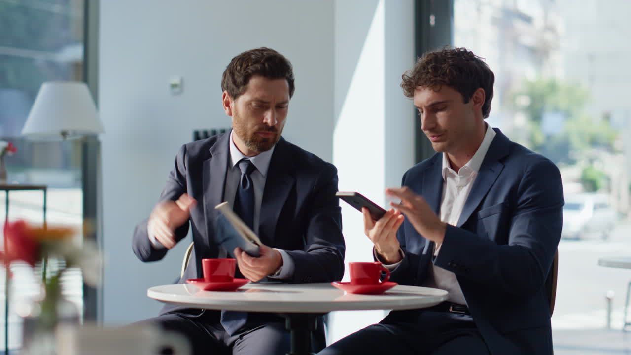 Nervous manager calling smartphone cafe closeup. Two startupers working talking