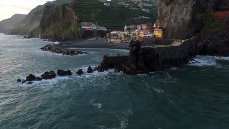 vibrant colorful town of ponta do sol madeira, portugal at sunset, aerial establish reveals out to ocean