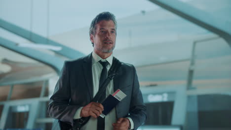 man at the airport with passport and boarding pass