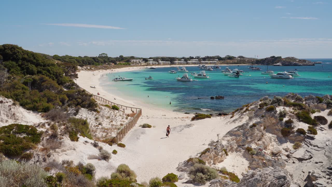 Persona che sale sulle dune di sabbia sull'isola di Rottnest a Perth, Australia Occidentale.