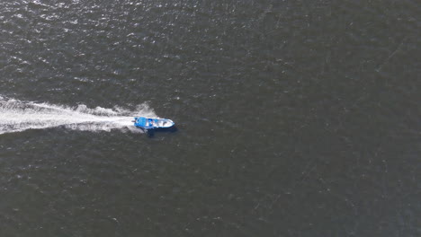 top down aerial footage following a speedboat going through the water