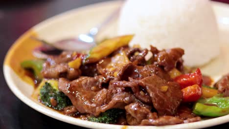 delicious stir-fried food served with rice