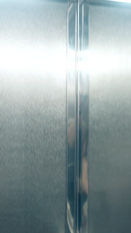 inspiring close view long haired brunette girl in summer dress kisses handsome man holding jacket sides in lift