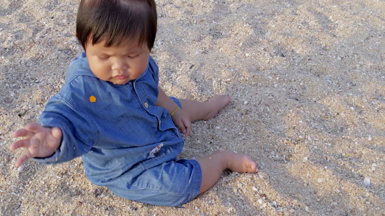 Toddler playing the sand beach family moment sunny day close-up joyful childhood exploration