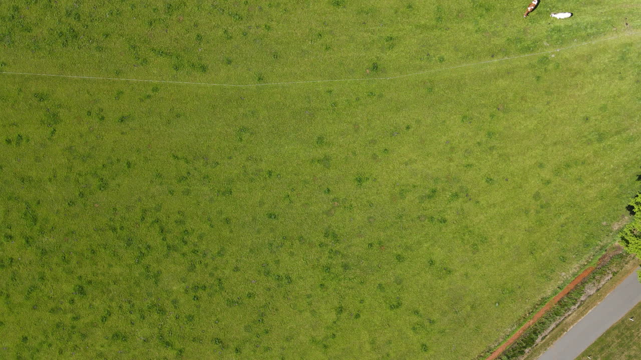 Aerial drone shot of farmland with roads and fields.