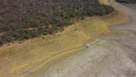 aerial drone shot of a dried up lake reservoir along forest at harsi dam in gwalior india