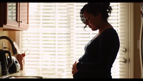 a journey of anticipation: capturing the beauty of pregnancy in serene moments within a cozy kitchen setting