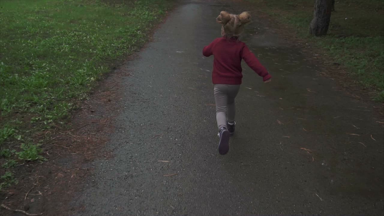 Little Girl Running Through Park
