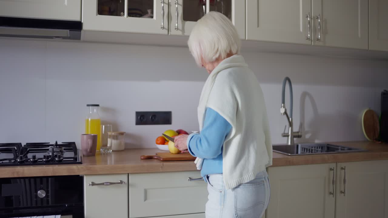 Senior Woman Preparing Food in Kitchen